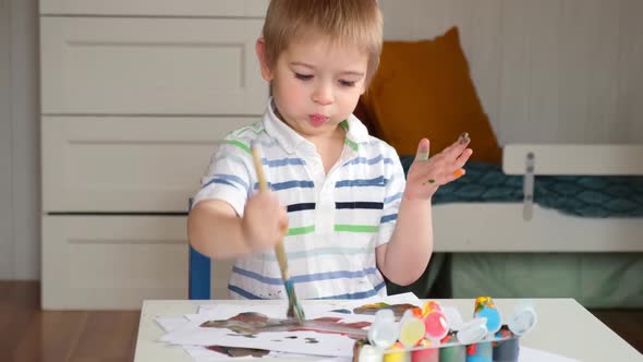 Little Boy Draws Picture On Paper