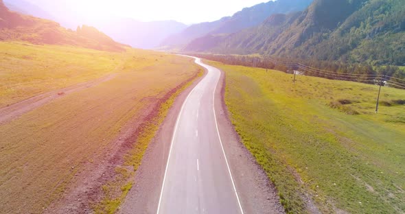 Flight Over Mountain Asphalt Highway Road and Meadow