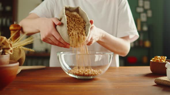 Grocery Putting Chickpeas in Bowl Closeup