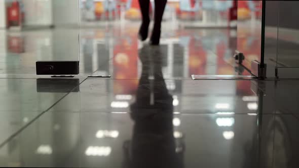 Office with Glass Door and Go Female Legs in Black Shoes