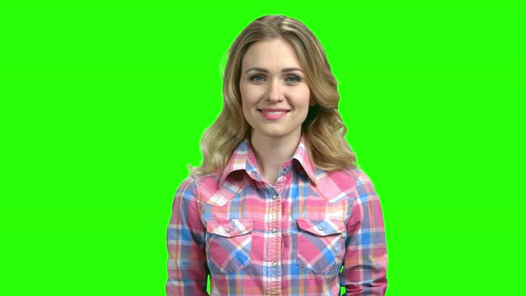 Young Woman in Checkered Shirt Looking at Camera