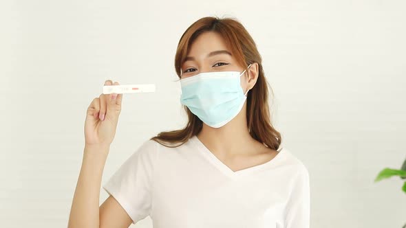 Beautiful Asian woman wearing a mask. Sick with the flu, stay at home