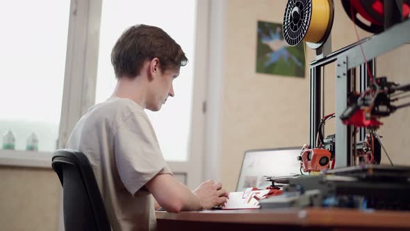 Man Using 3d Printer at Workplace