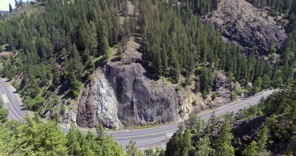 Aerial view of vehicles driving along a winding mountain highway in Washington State.