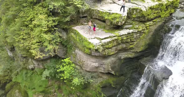 Tilt down, waterfall and rocks, people want to jump, Doubs river, Neuchâtel, Switzerland