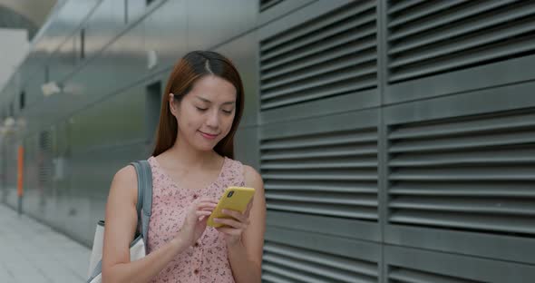 Woman use of mobile phone in city