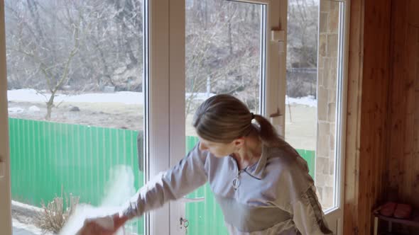 A Woman is Cleaning the House She Washes the Windows