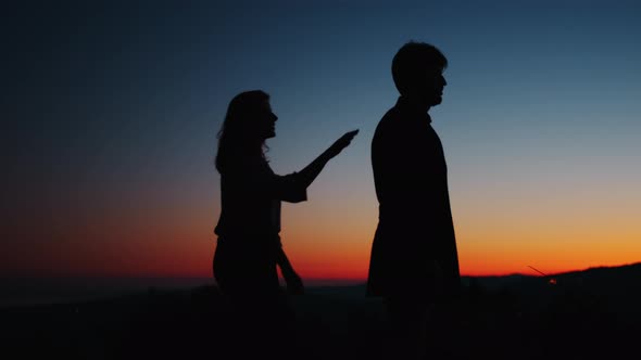 Silhouette of couple embracing at sunset in Valentine's day