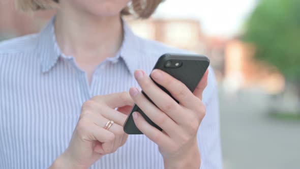 Close Up of Woman Using Smartphone While Standing Outdoor