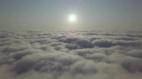 View From a Drone on a Sea of Clouds to the Horizon at Dawn