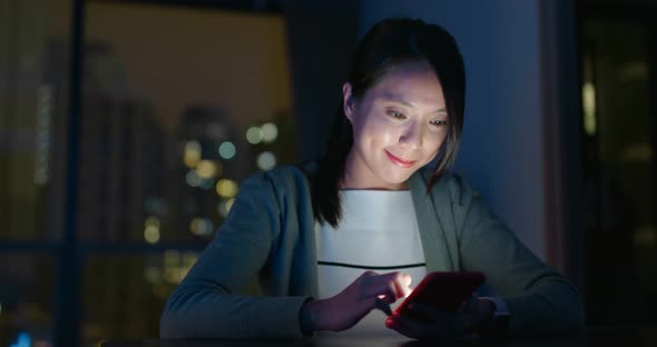 Woman look at smart phone at night