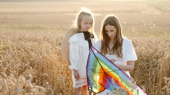 A Mother and Daughter Preparing To Fly a Kite