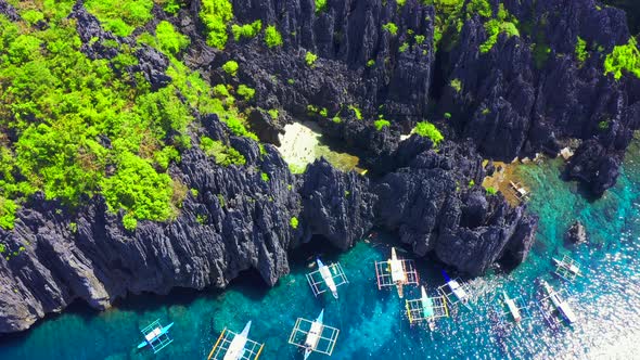 Aerial Drone View of Swimmers Inside a Tiny Hidden Tropical Lagoon Surrounded By Cliffs - Secret