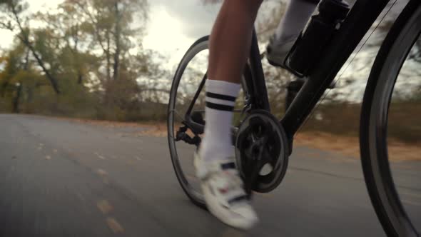 Cyclist Training Leisure Twists Pedals On Triathlon Bicycle. Gear System  And Bike Wheel. Workout.