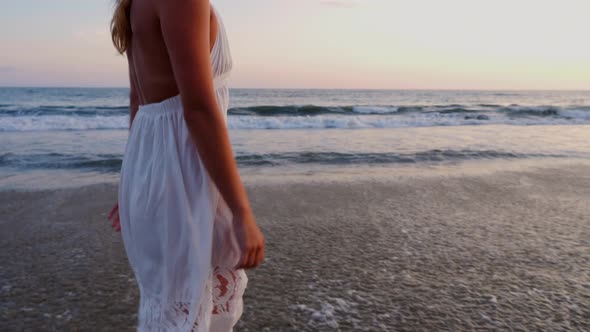 Attractive Woman Enjoying The Beach At Sunset