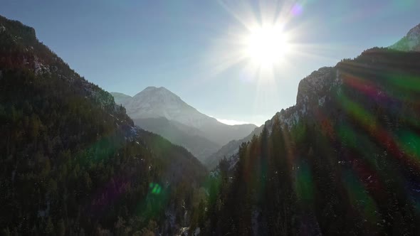 Flying through deep canyon as the sun shines high above