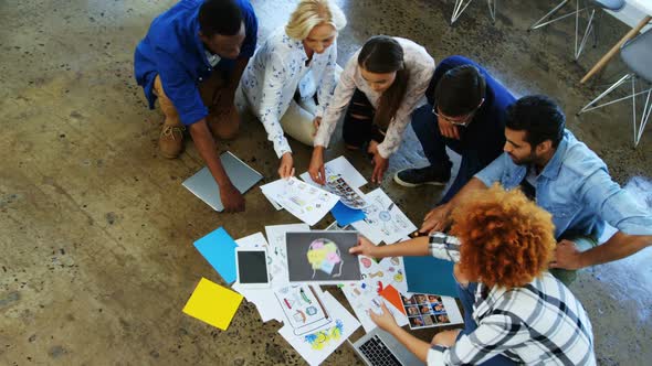 Team of executives discussing over document in the meeting