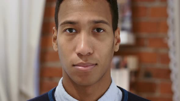 Portrait of Serious Young African Man, Loft Background