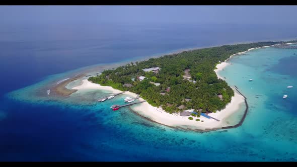 Aerial drone shot panorama of luxury bay beach trip by shallow lagoon with bright sandy background o