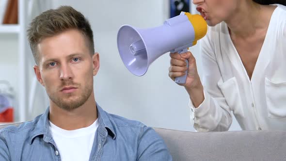 Annoyed Female Shouting in Megaphone on Husband, Relationship Difficulties