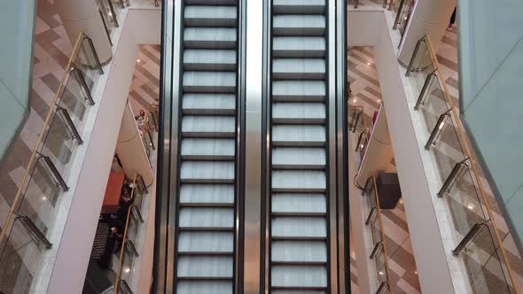 4K shot of empty moving staircase running up and down in shopping mall. Modern escalator stairs