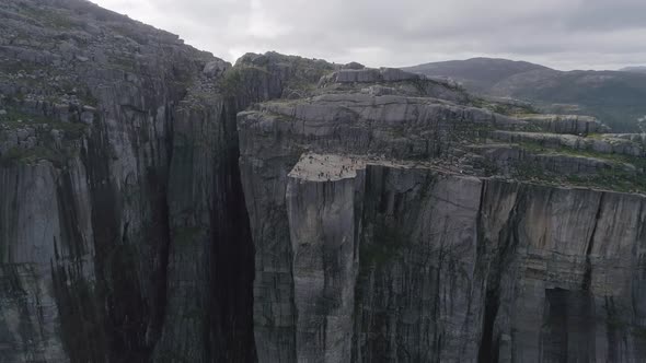 Aerial Slomo shot flying towards Preikestolen with Tourists Walking and Photographing the Scenery. S