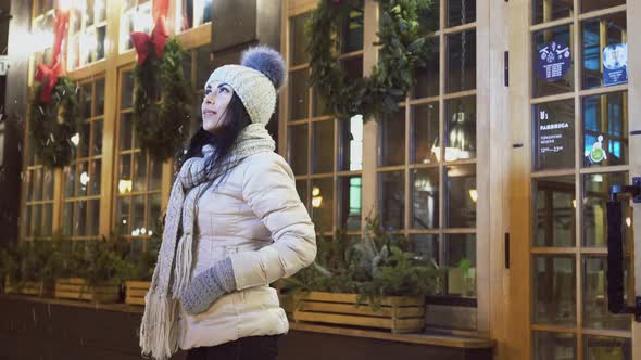 Girl Near Coffee House Looking at Falling Snow