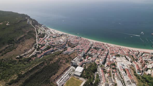 Aerial circle view from above of wonderful sea of Sesimbra, Portugal. Real time