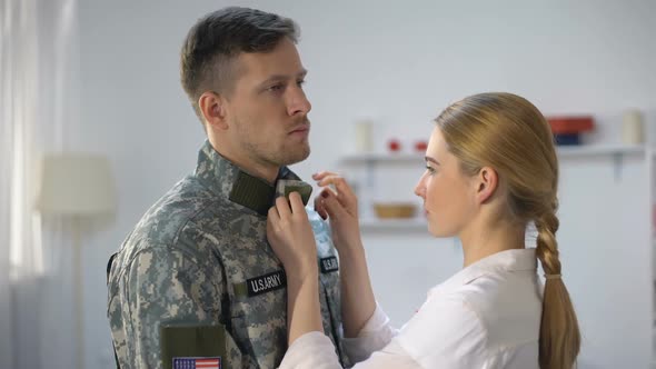 Upset Woman Adjusting Uniform and Hugging US Soldier, Military Service Farewell