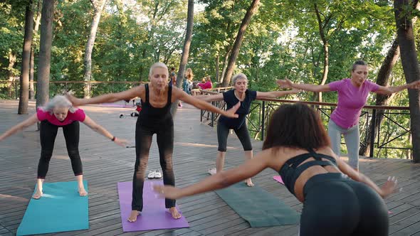 Group of Active Senior Women Making Breathing Exercise and Applauding to Themselves Enjoying