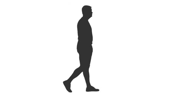 Silhouette of Adult Man in Shorts Walks With Hands in Pockets alt
