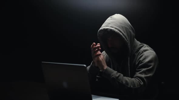 Remote View of Unrecognizable Hacker Man Stretching Hands and Starting To Typing on Laptop Keyboard