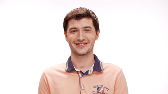 Happy Young Handsome Man Smiling Over White Background Slow Motion