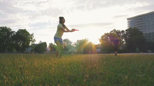 Young and Beautiful Woman Playing Frisbee in the Park Slow Motion