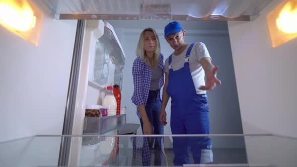 The refrigerator repairman and the landlady hug, hint at sex.