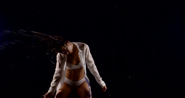 Sexual Half Naked Woman Is Dancing Under Rain in Darkness, Waving By Wet Hair