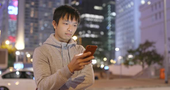 Man use of smart phone in the city at night