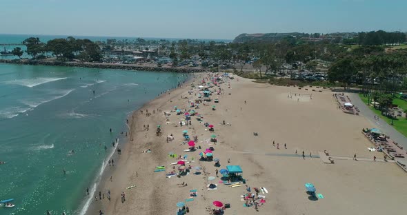 DANA POINT, California. Doheny State Beach. A Sunny Day Beach Scene with People Engaged in Beach