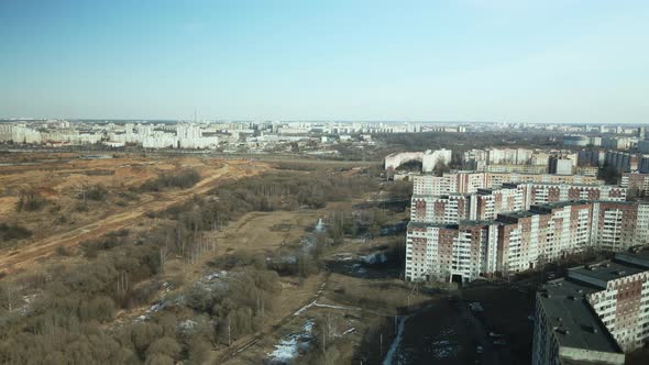 Suburb of a big city. Flight at sunset.