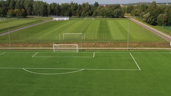 Top View of a Football Field with Green Grass Outdoors in Summer