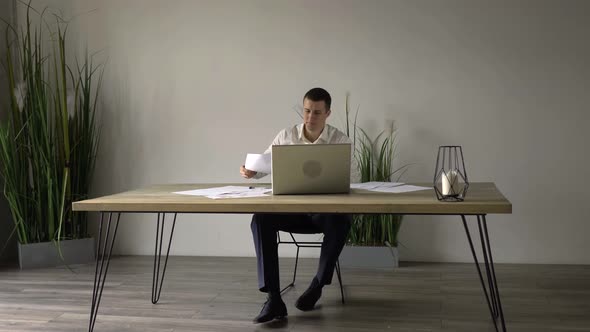 middle-aged man works in the office with documents