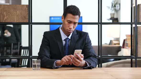 Black Businessman Browsing on Smartphone