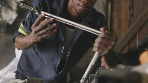 African man repairing car