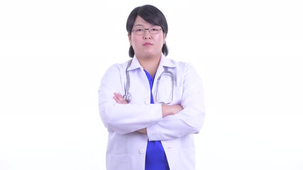 Happy Overweight Asian Woman Doctor Smiling with Arms Crossed