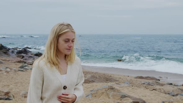 Blonde Woman Is Walking On Sea Coast