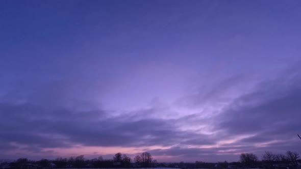 Time lapse sunrise and clouds. Purple beautiful sky in winter