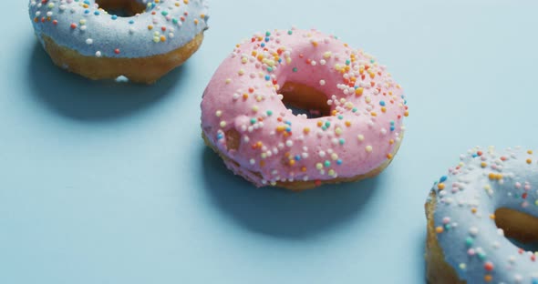 Video of donuts with icing on blue background