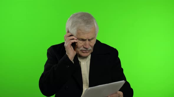 Elderly Stylish Caucasian Grandfather Man Dissatisfied Talking on Mobile Phone