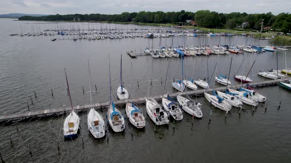 Sailboat harbor on an overcast day. Drone footage of boats in the water.