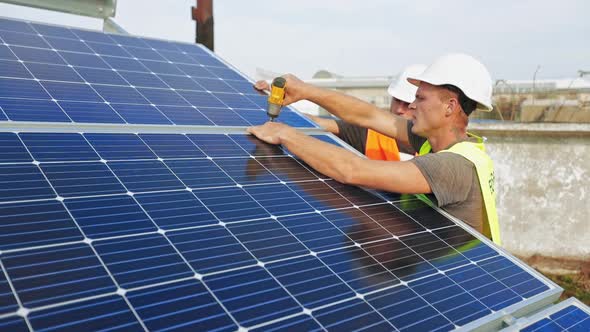 Technician installing solar cell. Technicians mounting photovoltaic solar panels